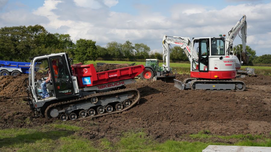 digger behind tracked dumper