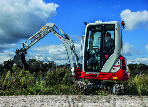 side on view of red takeuchi tb320 digger